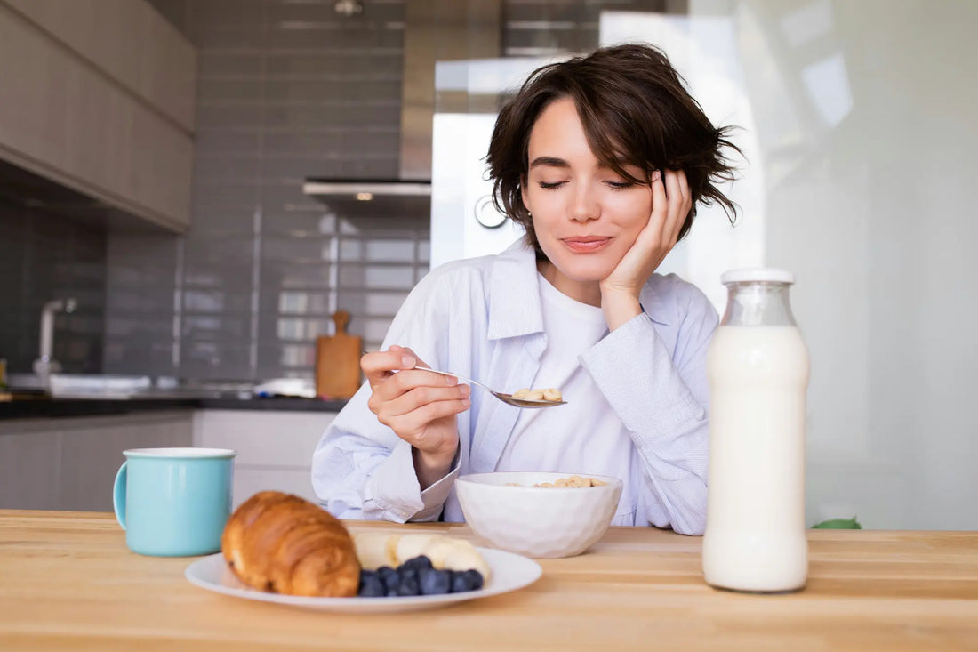 a woman eating cereal from a bowl with a spoon
